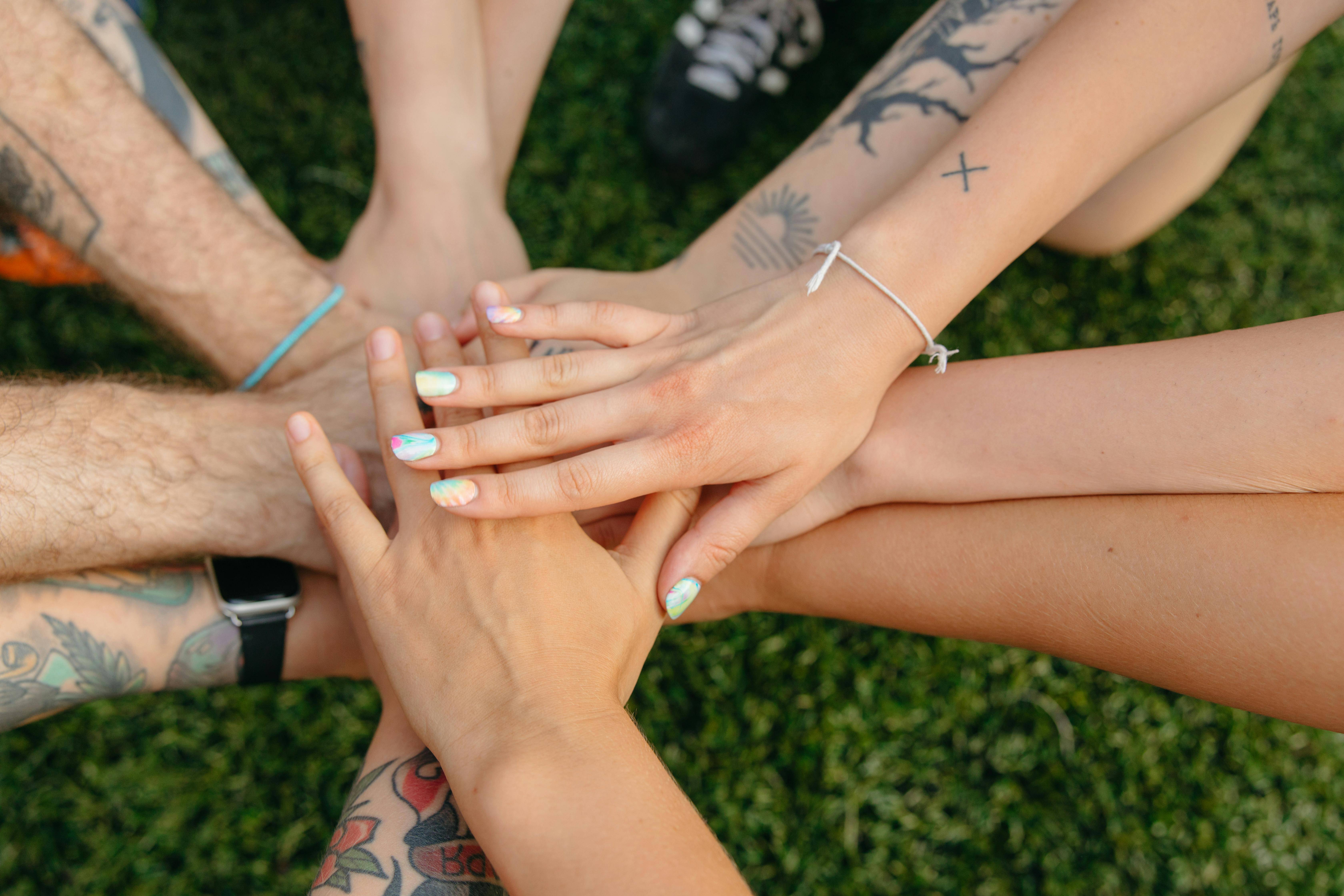 Community support, diverse group holding hands